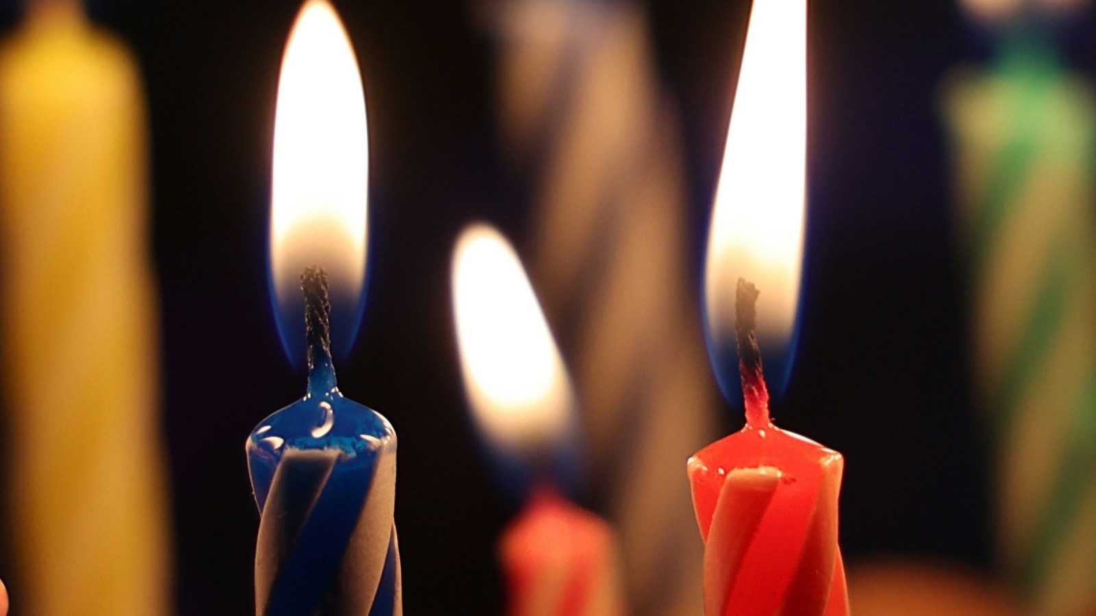 Lit birthday candles on cake for a personalized song for Mom